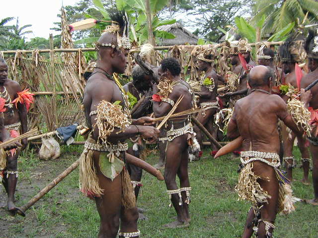 Note the large penis gourd being worn by one of the men